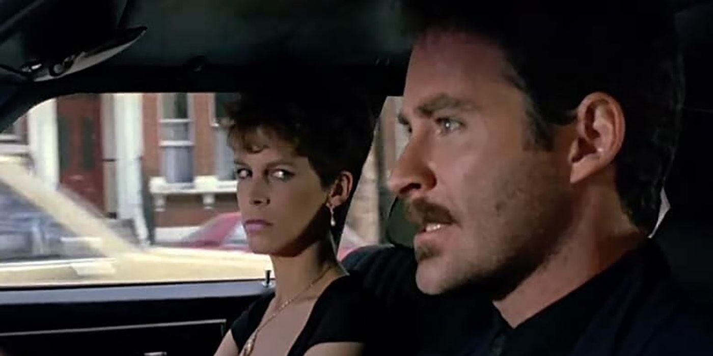 Jamie Lee Curtis in A Fish Called Wanda giving a male driver a dirty look while sitting in the passenger seat.