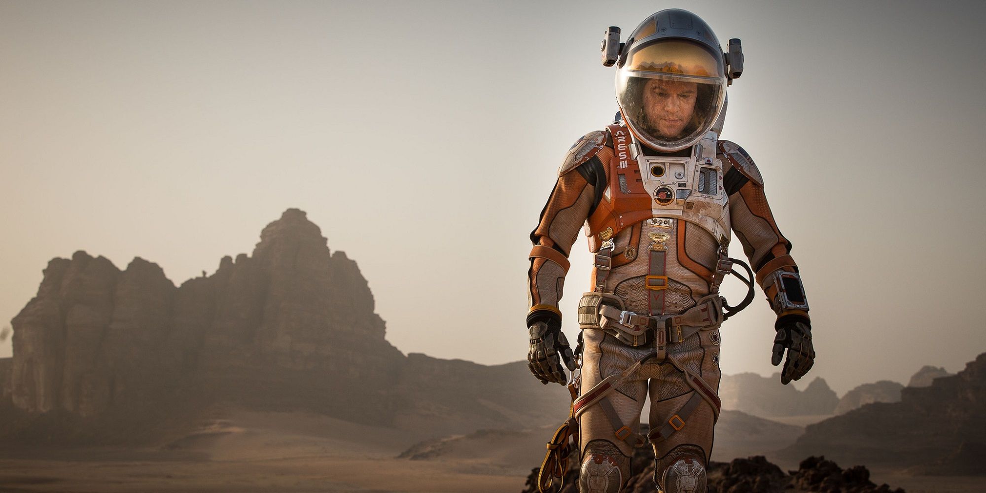 Matt Damon is Mark Watney in a spacesuit on Mars in The Martian.