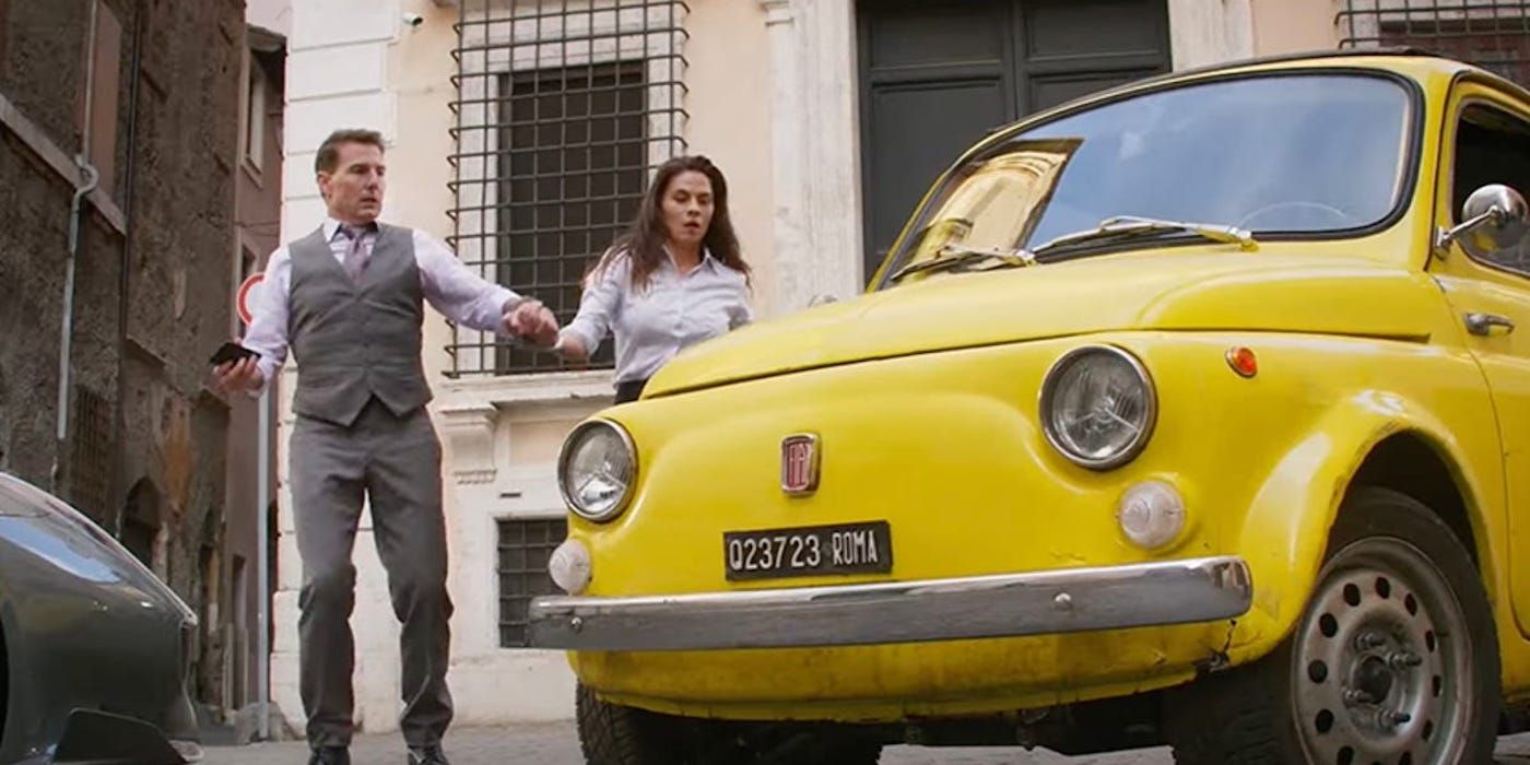Mission: Impossible 7's Hunt and Grace standing outside a yellow Fiat buggy 