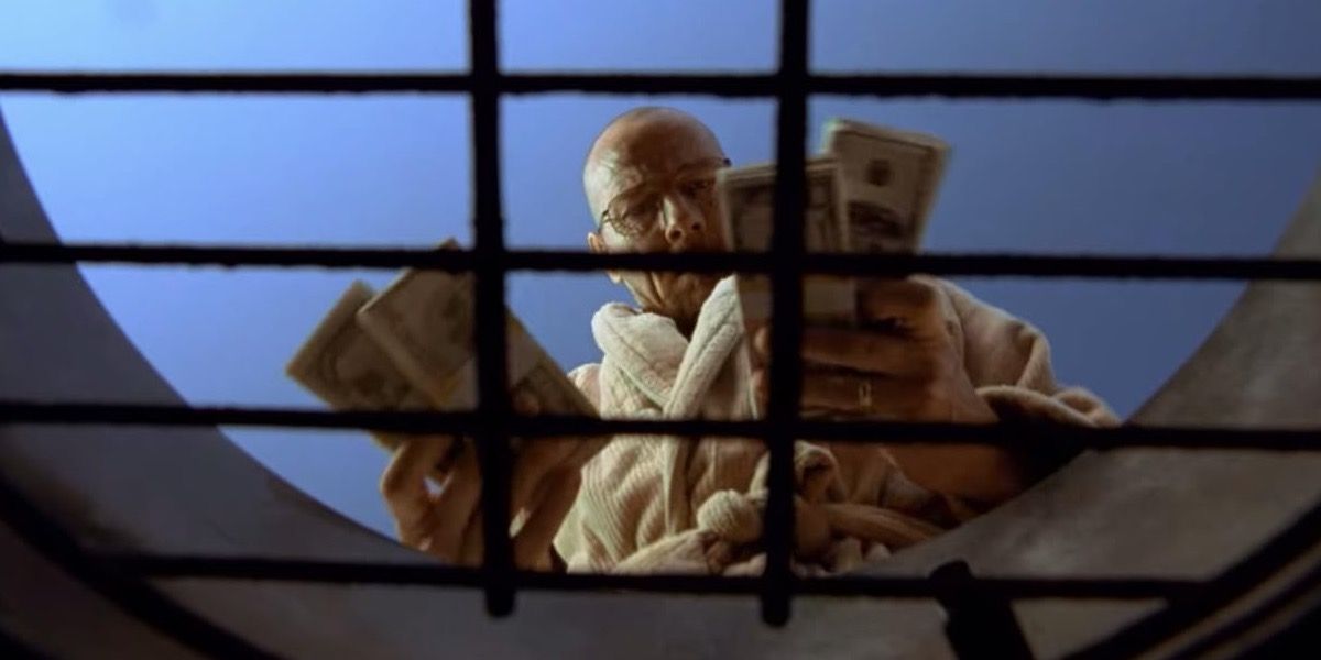 Walter about to burn cash on the barbecue grill in Breaking Bad