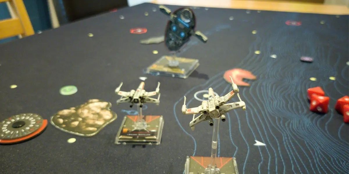 A game of Star Wars: X-Wing being played.