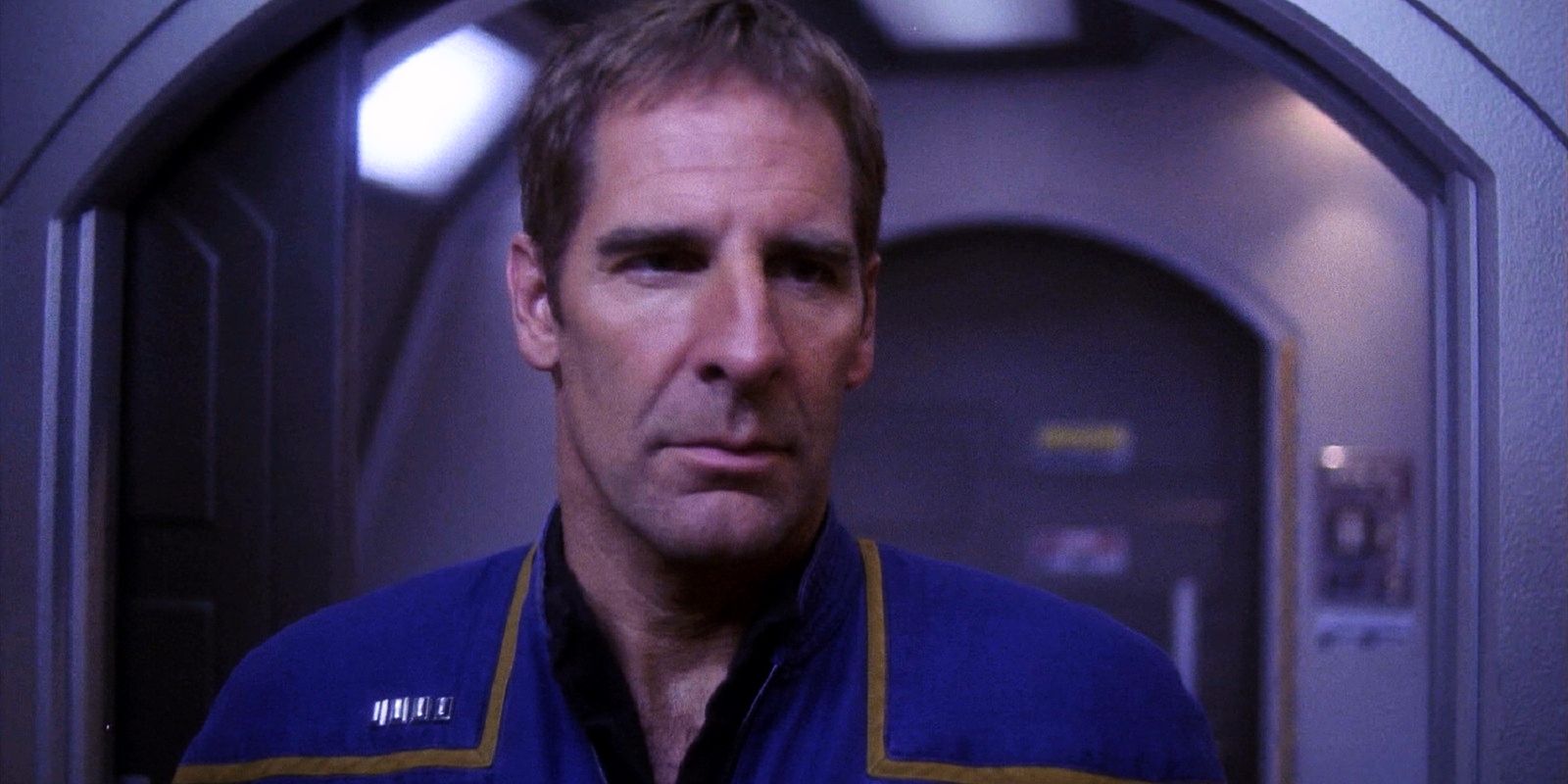 Captain Archer standing in his Enterprise ready room looking angry and stern
