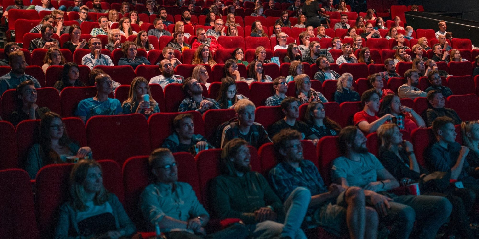 Fans at a movie theater facing the screen. Stock photo.