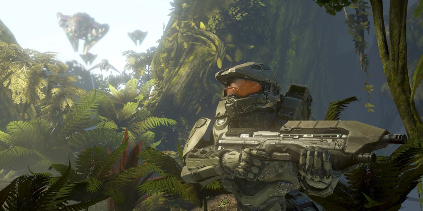 Master Chief stands in a jungle and holds a gun in Halo 4