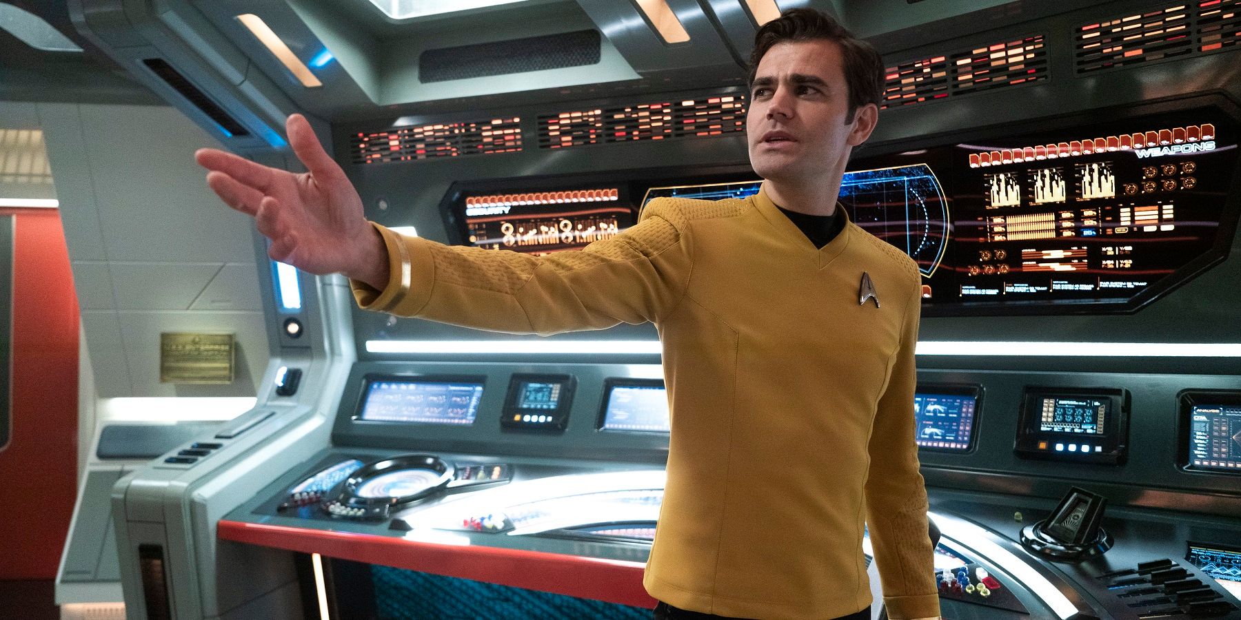 Paul Wesley's Jim Kirk holding out his hand singing on the bridge of the Enterprise, Strange New Worlds