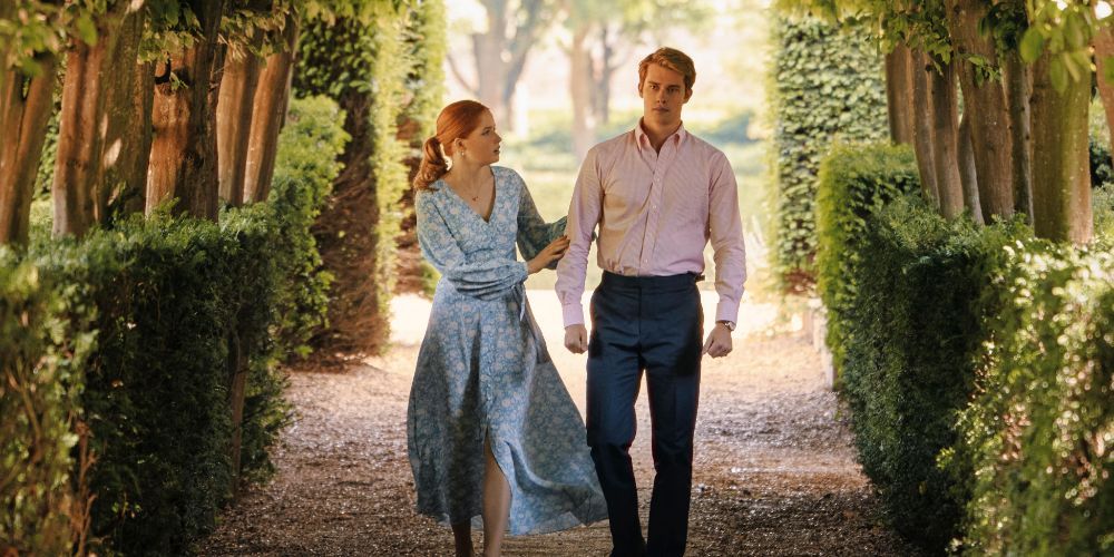 Ellie Bamber as Princess Bea and Nicholas Galitzine as Prince Henry take a garden stroll in Red White and Royal Blue