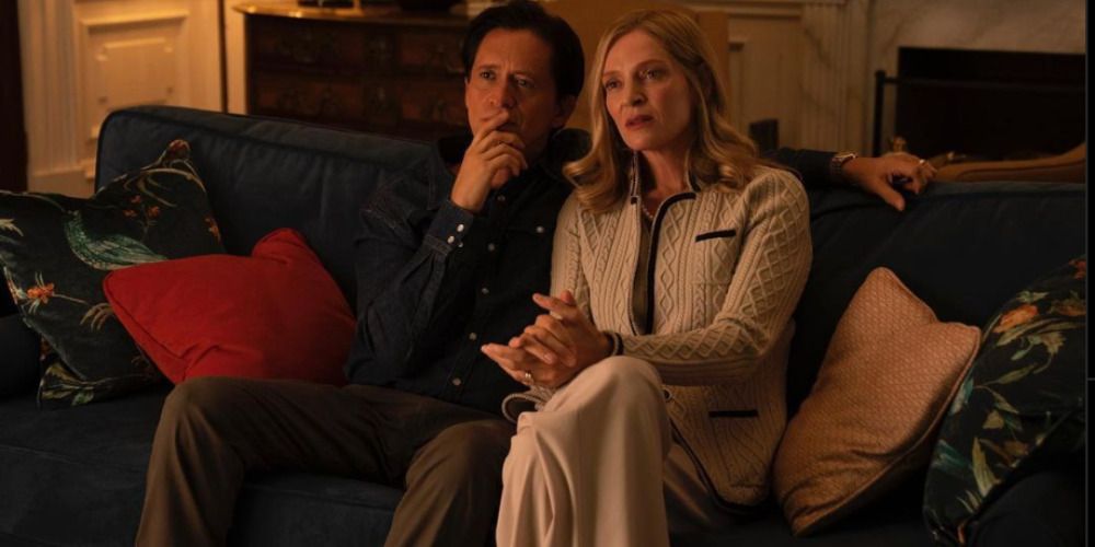 Clifton Collins Jr and Uma Thurman as Oscar Diaz and Ellen Claremont in Red White and Royal Blue watching TV on a couch