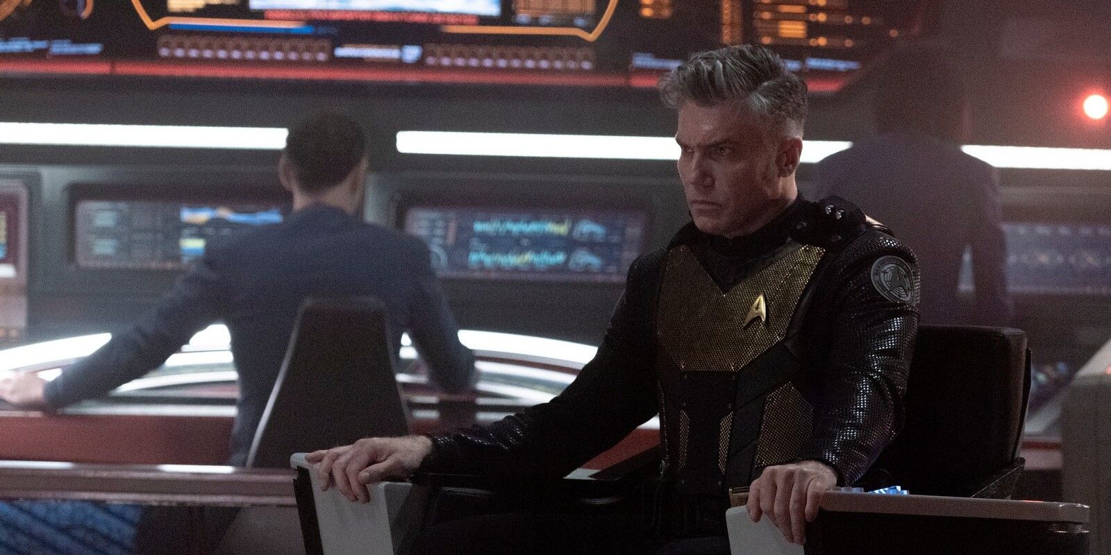 Star Trek: Strange New Worlds Pike in tactical gear sitting in the captain's chair