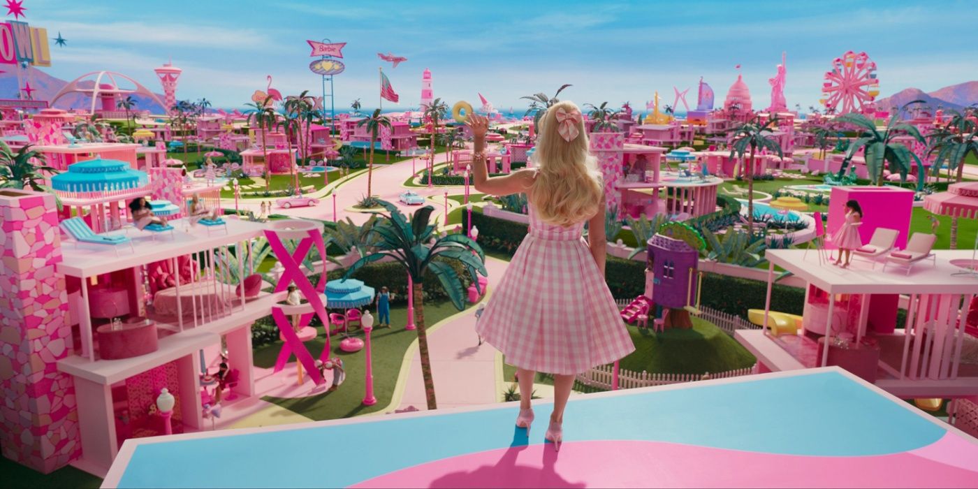 Margot Robbie as Stereotypical Barbie saying hello to the other Barbies in Barbieland.