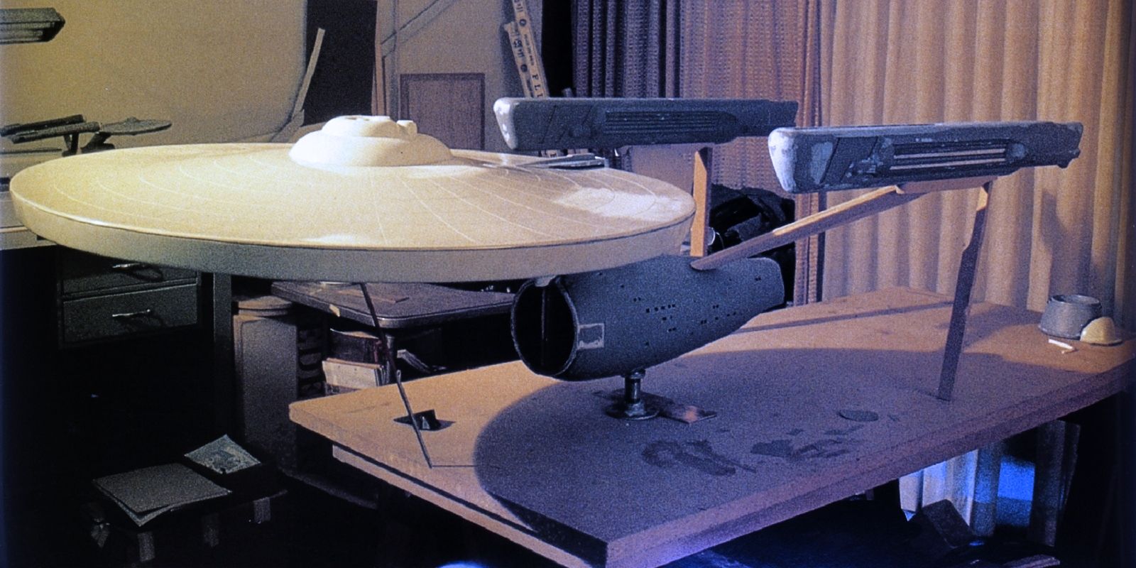 The unfished Star Trek Phase II filming model of the USS Enterprise, sitting on a table via Paramount