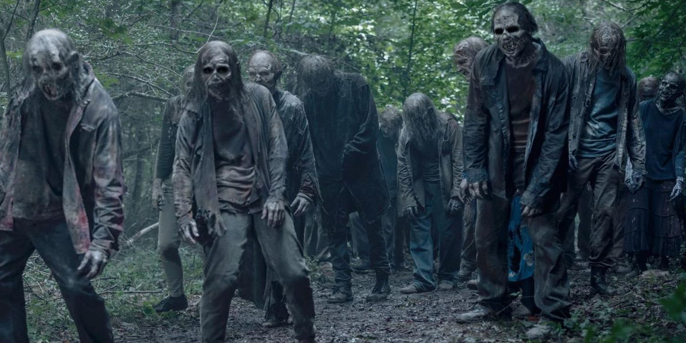 A horde of walkers walks in the forest in The Walking Dead