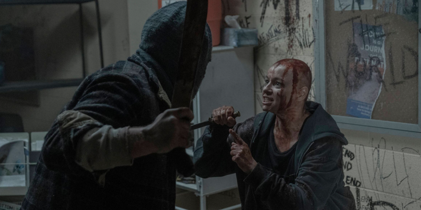 Alpha (Samantha Morton), covered in blood, confronts Beta with a mask on in The Walking Dead