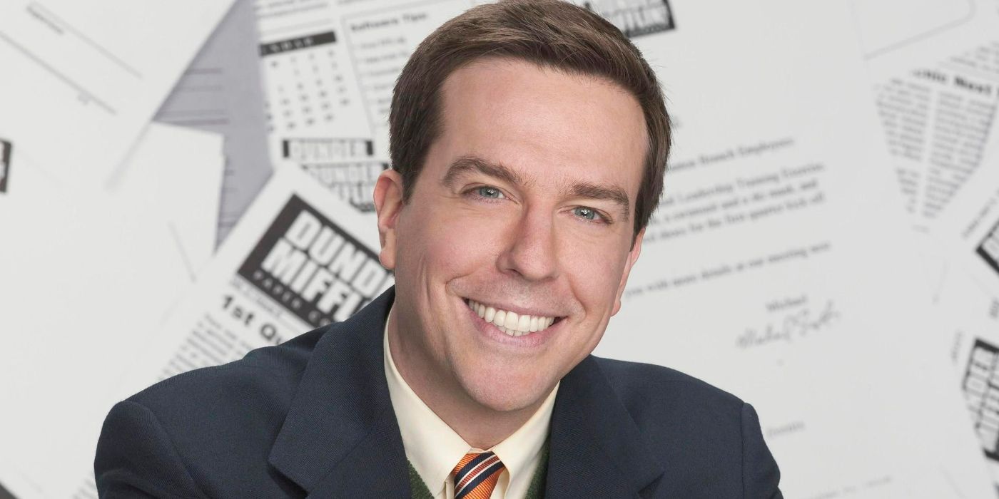 The Office's Andy Bernard smiles into the camera while in a paper-filled background