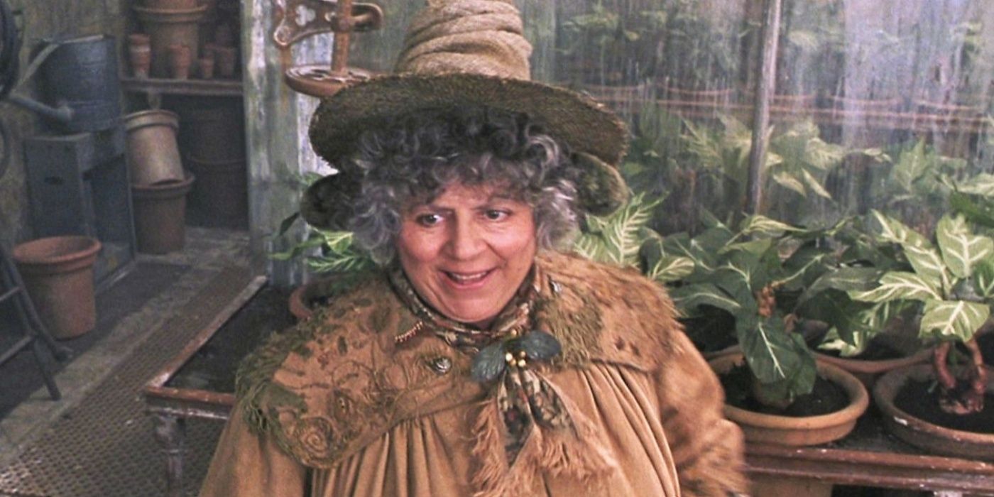 Professor Sprout smiles near newly potted mandrakes in Harry Potter and the Chamber of Secrets