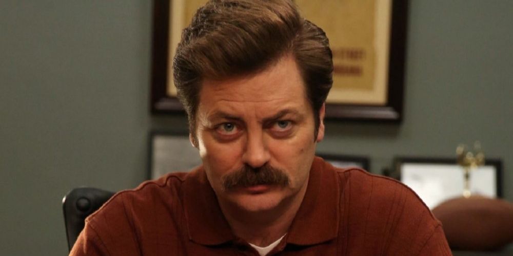 Nick Offerman as Ron Swanson at his desk in Parks and Recreation