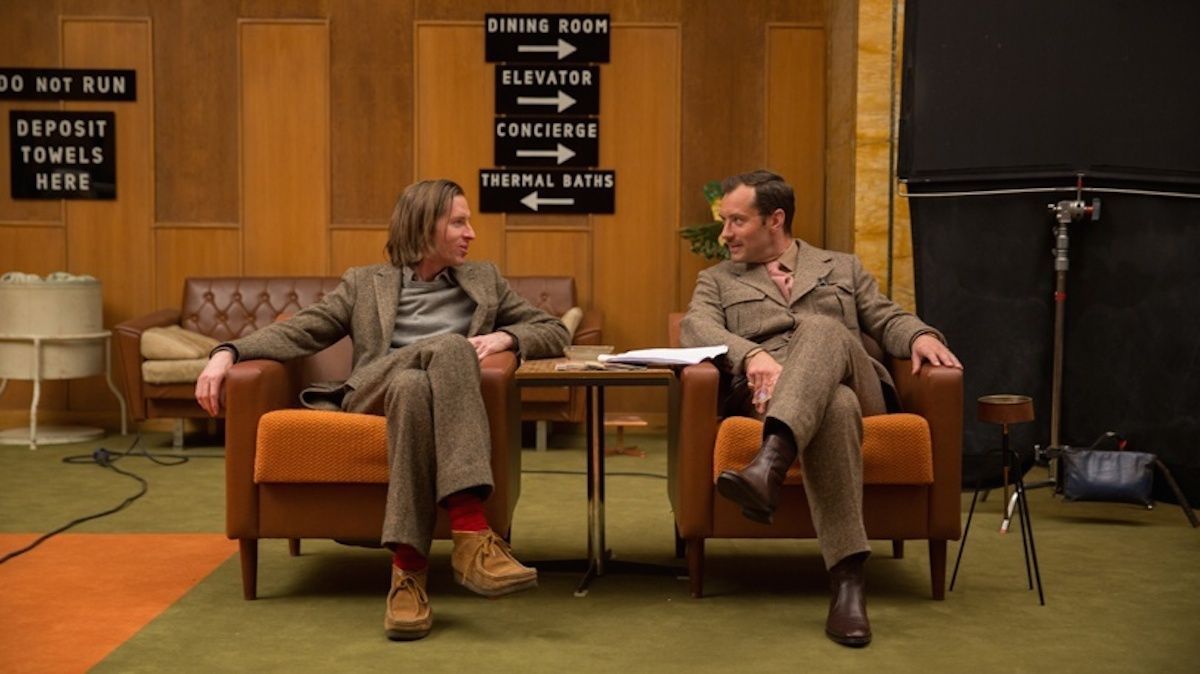 Wes Anderson sitting with Jude Law on the set of The Grand Budapest Hotel