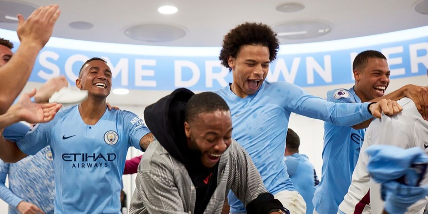 Team members from Manchester City cheering and celebrating.