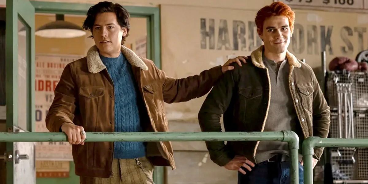 Riverdale's Jughead standing with his hand on Archie's shoulder