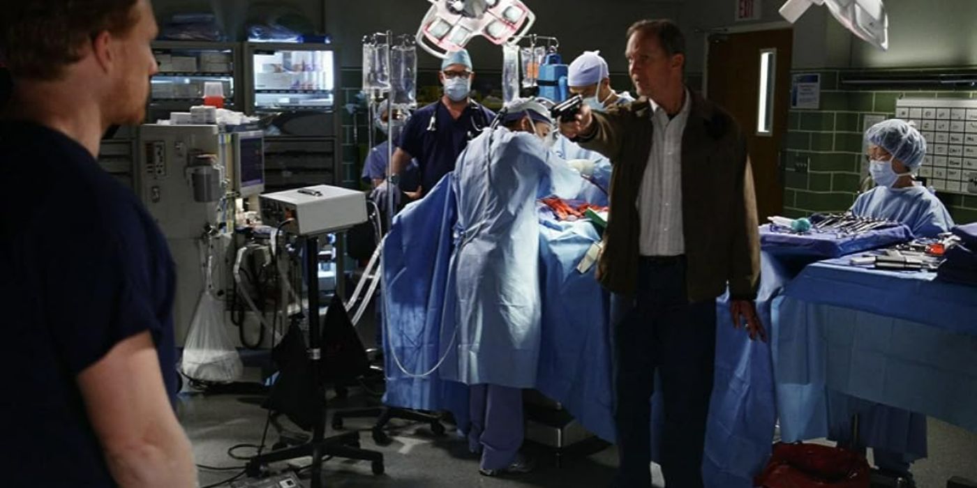 A few doctors perform a surgery and a gunman aims his weapon at Owen Hunt in Grey's Anatomy