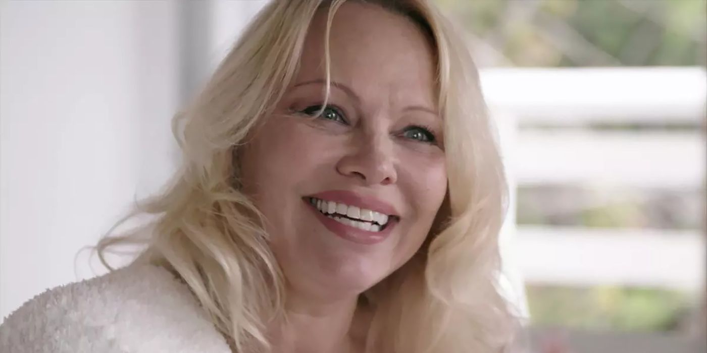 A close-up of Pamela Anderson smiling from the docuseries Pamela, A Love Story.