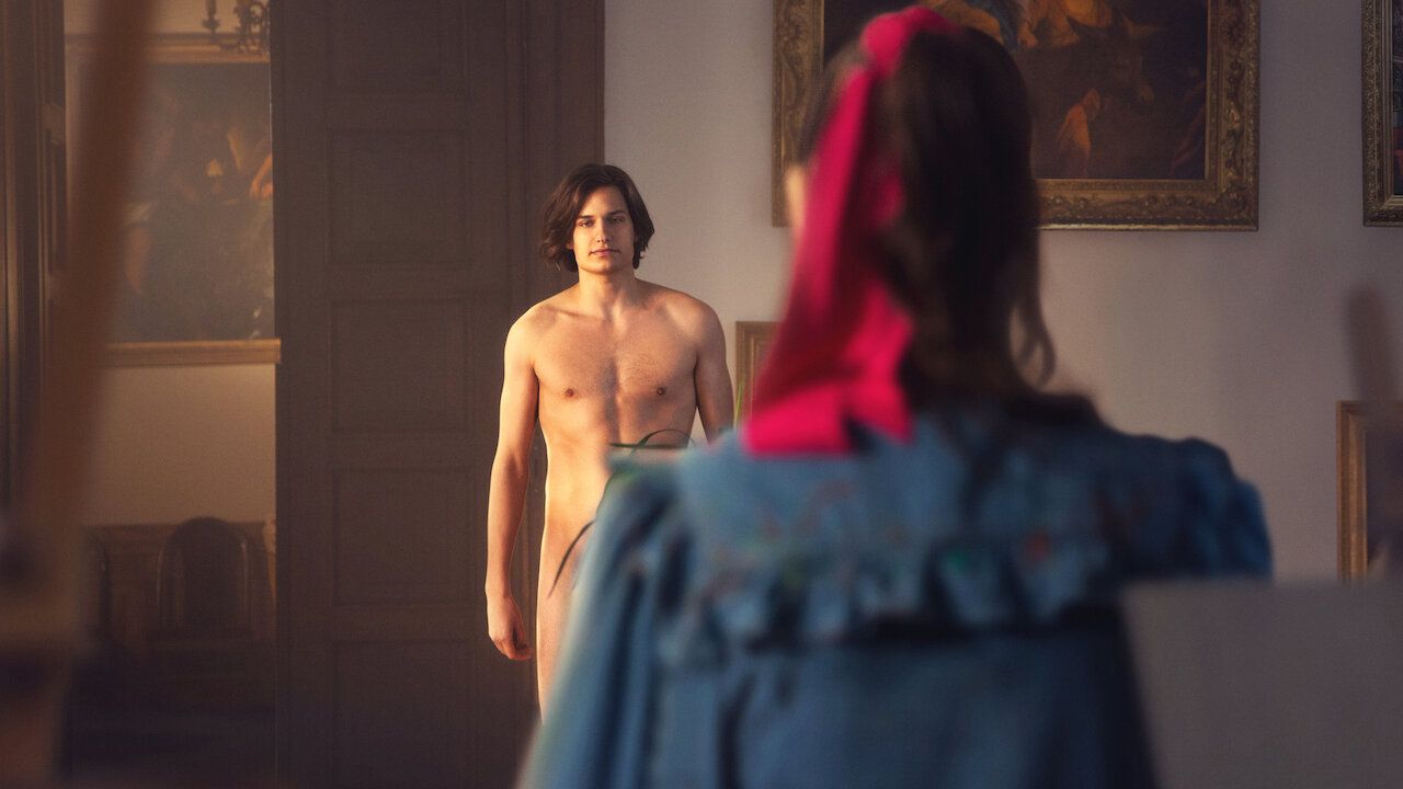 Adam stands naked with a woman conveniently blocking his lower half in Sexify