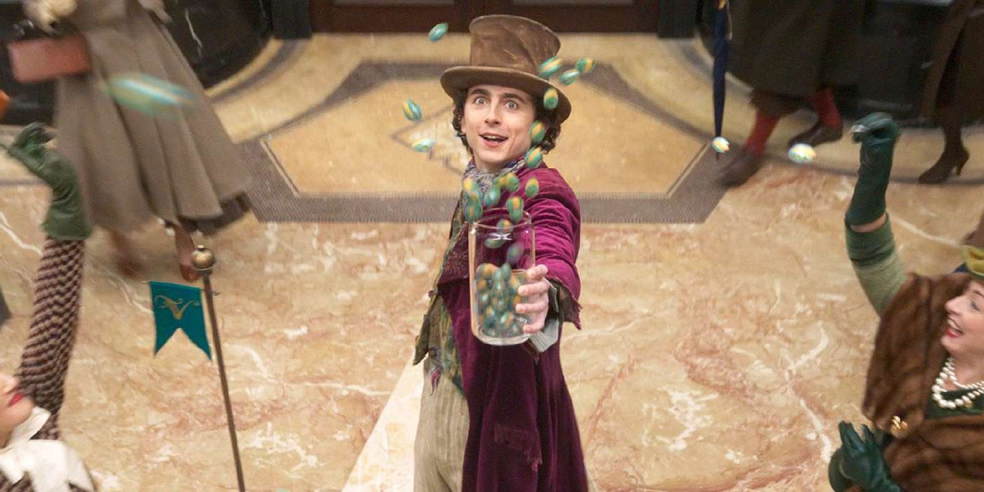 Willy Wonka holds magical candy in Wonka