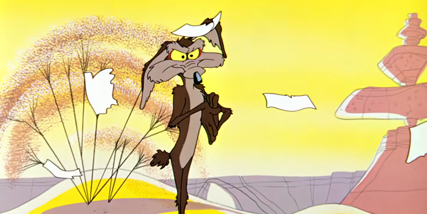 Wile E. Coyote from Looney Tunes stands with paper falling around him