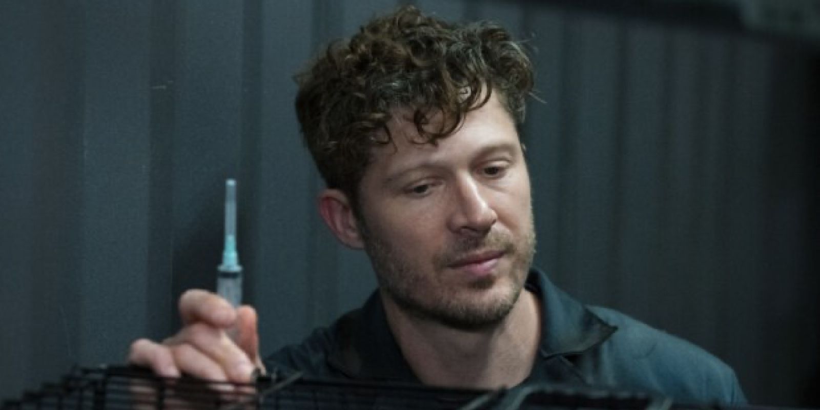 Zach Gilford’s Elias Voit holds up a syringe in Criminal Minds: Evolution Episode 3, “Moose.”