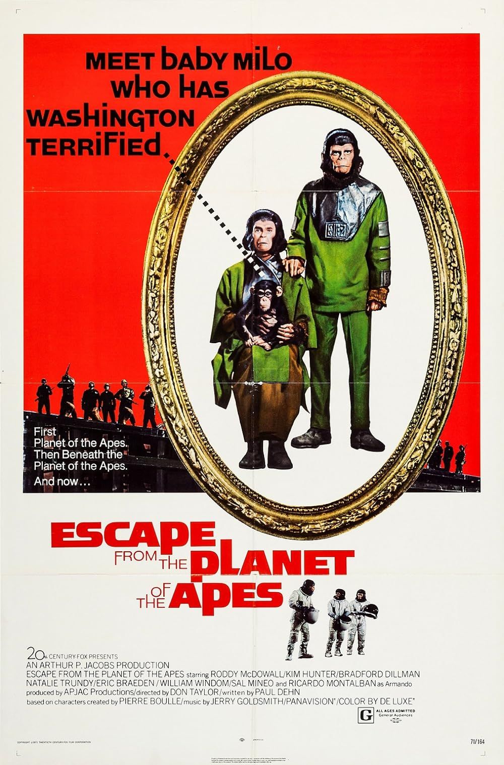 Cornelious and Zida hold a chimpanzee wearing green outfits in Escape from the Planet of the Apes.