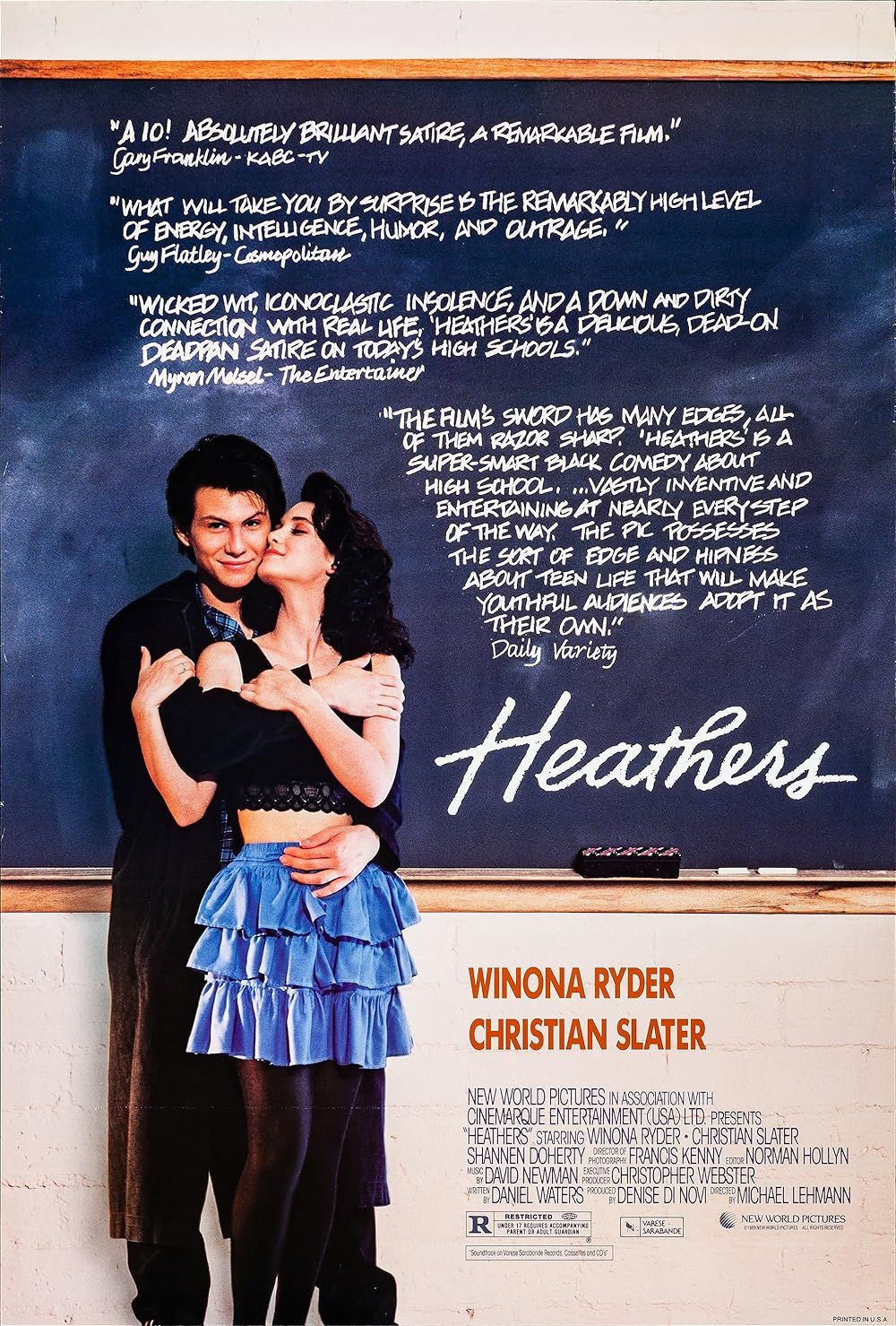 A couple embraces on the movie poster for Heathers (1988)