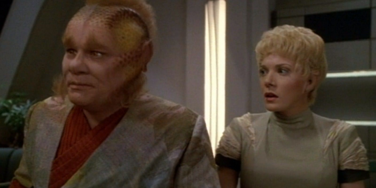 Neelix and Kes standing in the captain's ready room on the USS Voyager in the Star Trek series