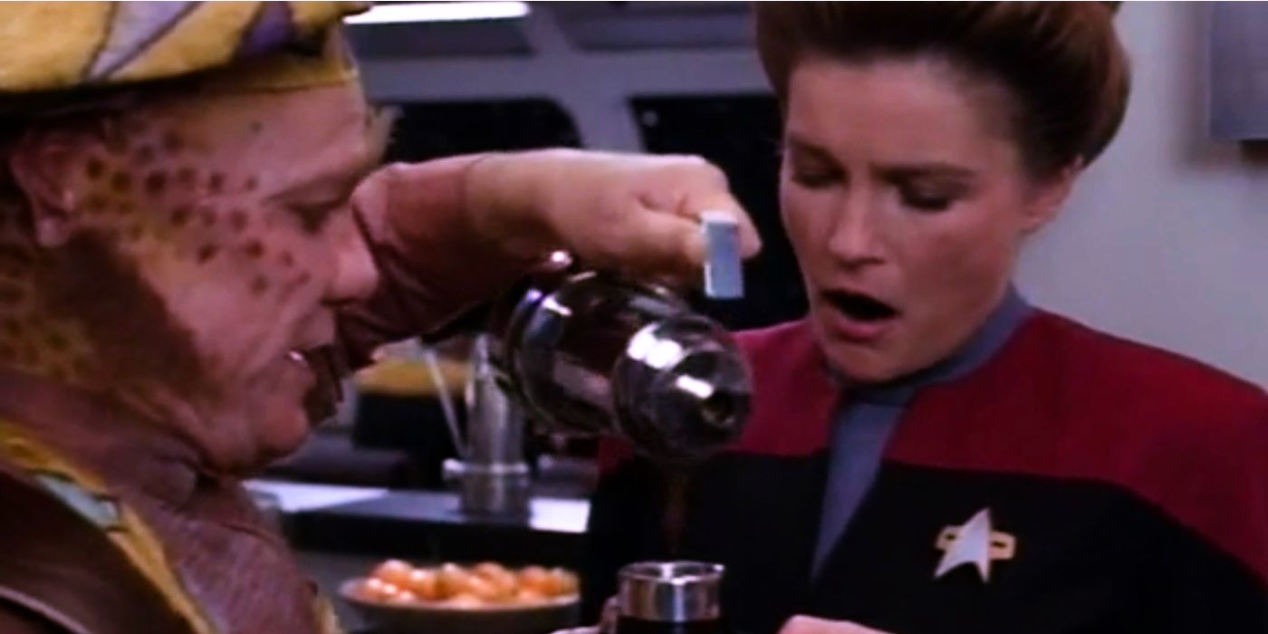 Neelix pouring a cup of gross coffee for Captain Janeway in the mess hall on Star Trek Voyager