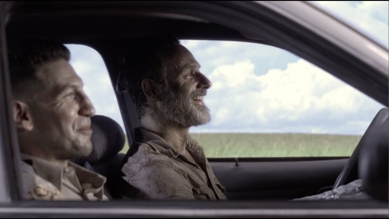 Rick and Shane laugh together in a car in The Walking Dead