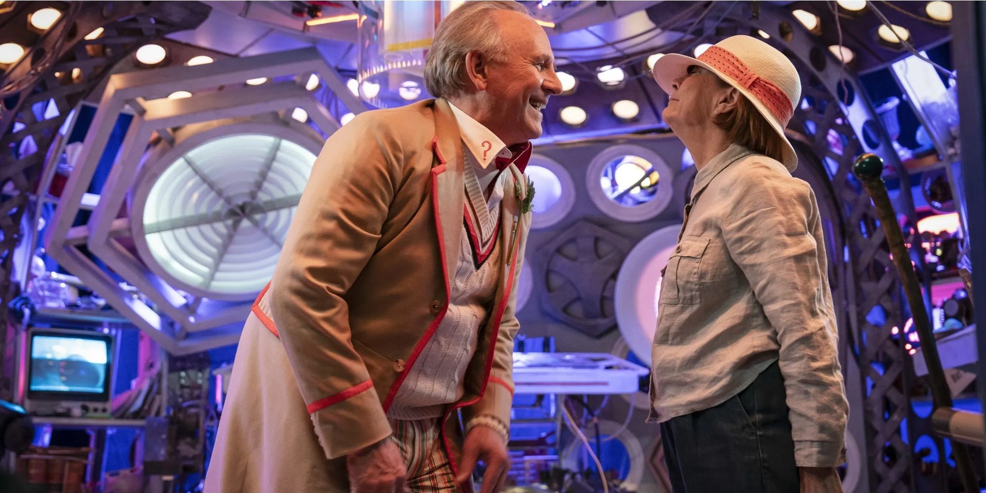 The Fifth Doctor and Tegan smiling at each other on the jumbled TARDIS set in Doctor Who Tales of the Tardis
