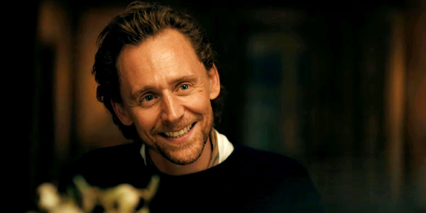 Golden Globe winner Tom Hiddleston is smiling at someone. 