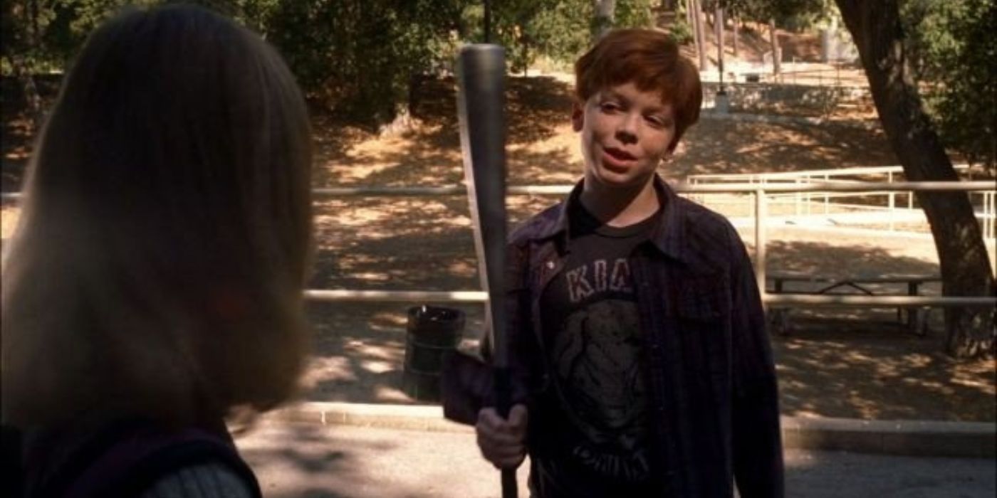 Jeffrey Charles threatens a little girl (Dakota Fanning) with an aluminum bat at a park.