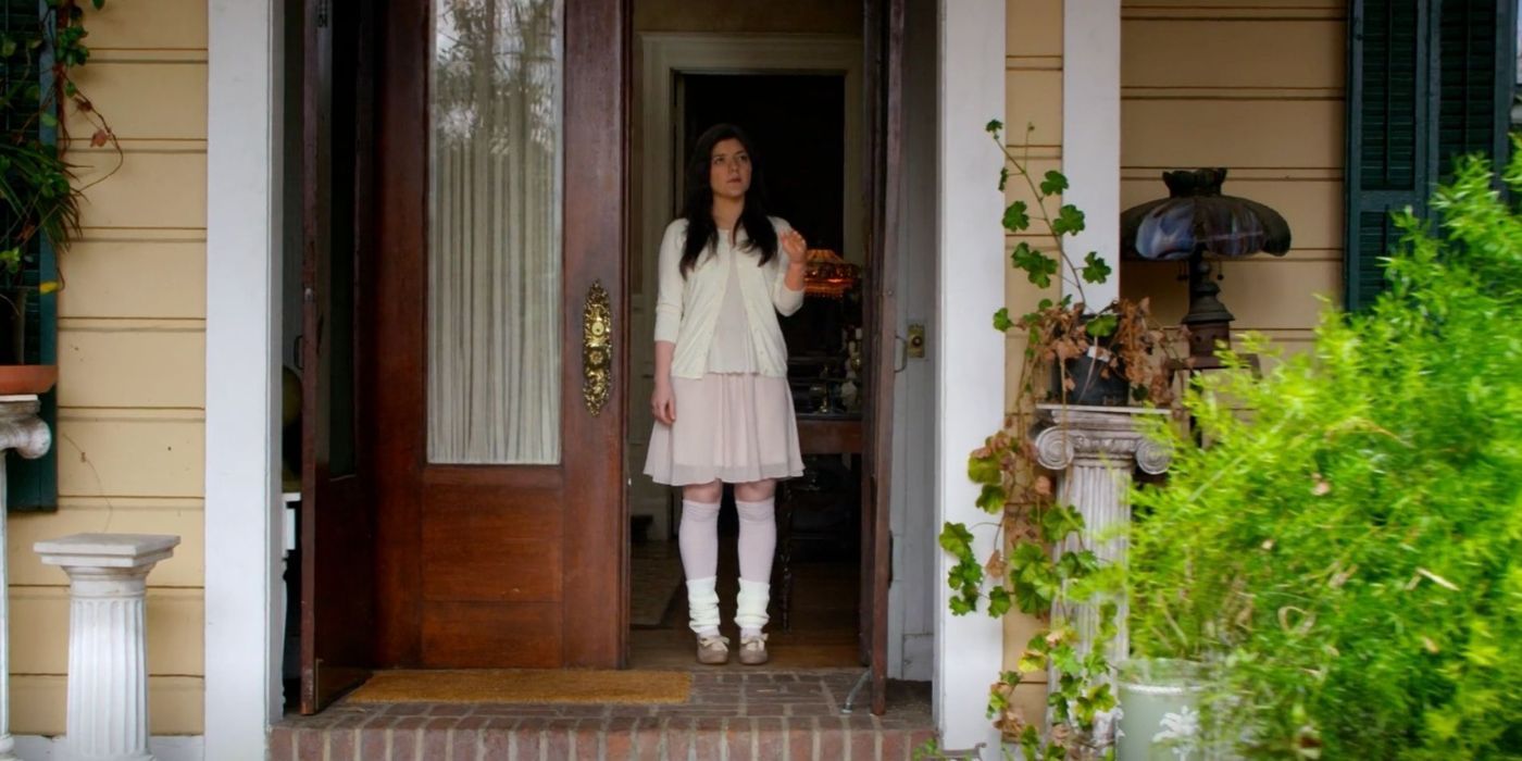 Lara Heathridge stands expectantly in the doorway of her home. 