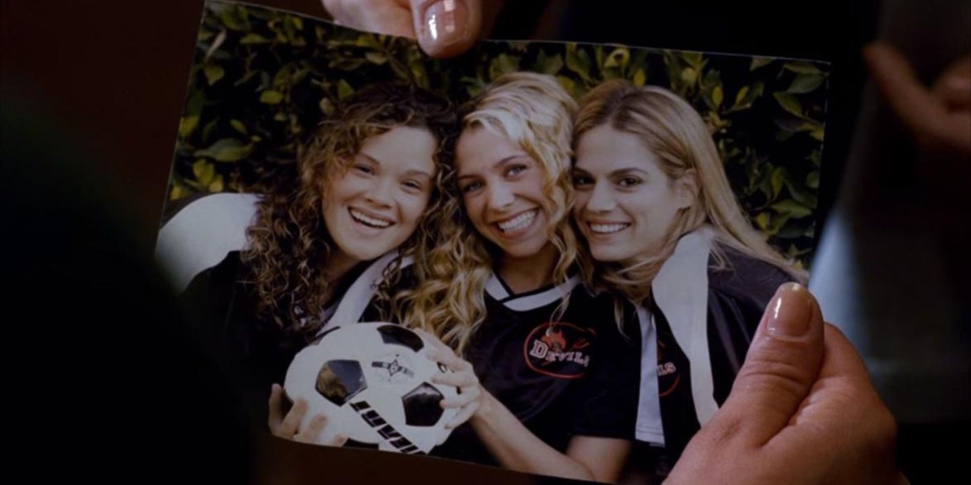 A photo of Brooke Chambers, Polly Homefeldt, and Kelly Seymour in their soccer uniforms.