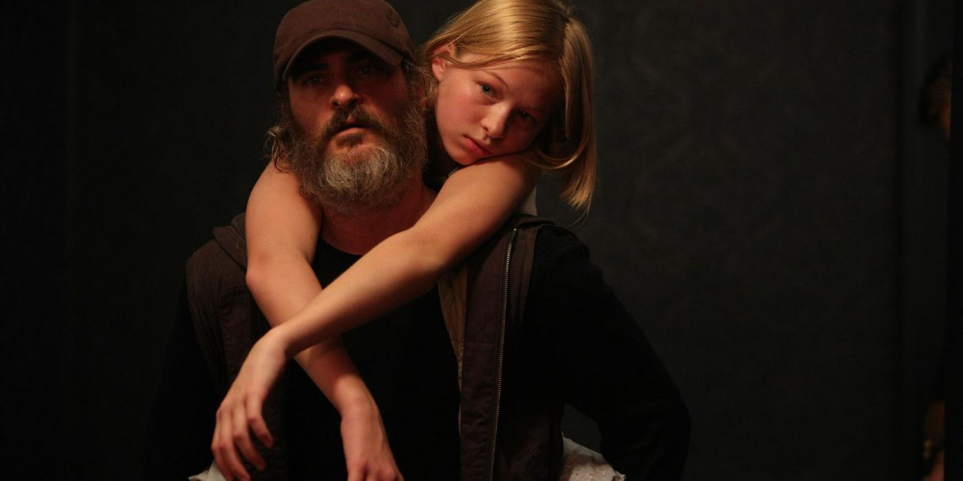 Joaquin Phoenix's Joe carries a girl on his back in You Were Never Really Here