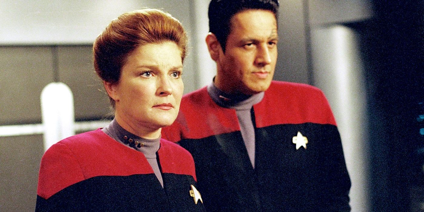Captain Janeway looking concerned and Chakotay looking stoic from Star Trek Voyager