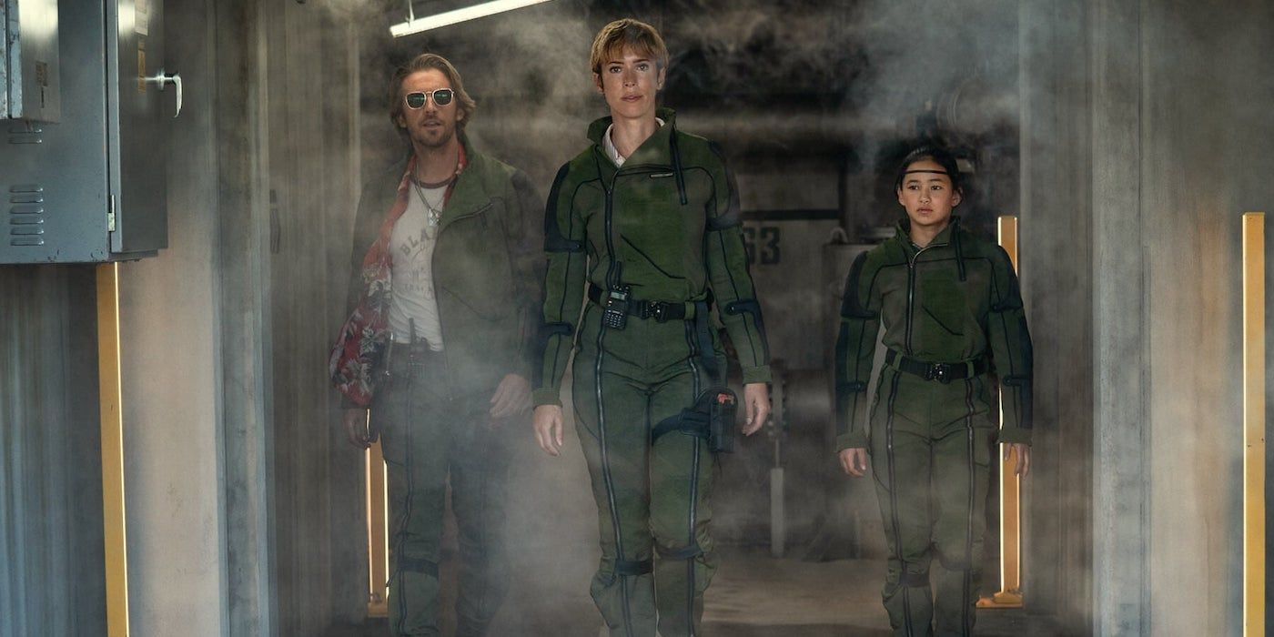Trapper (Dan Stevens), Ilene (Rebecca Hall) and Jia (Kaylee Hottle) walk together in Godzilla x Kong: The New Empire