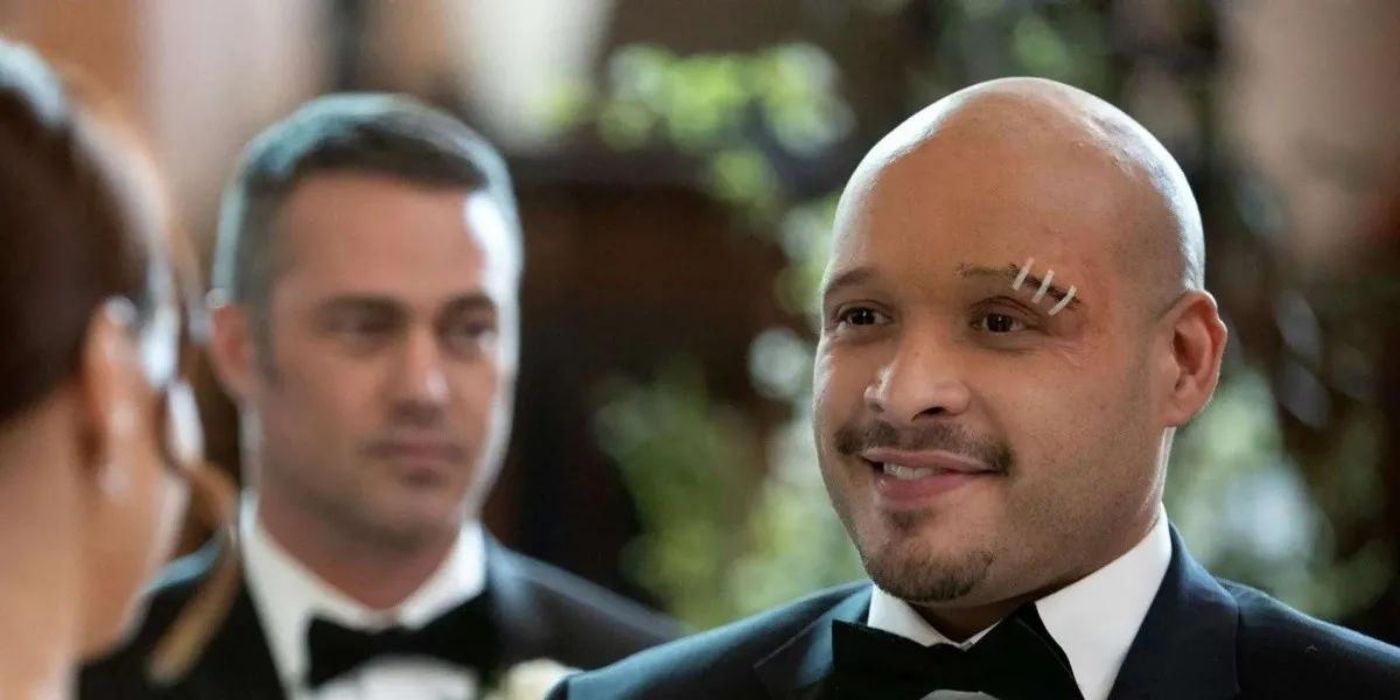 Joe Minoso stands at his wedding as Joe Cruz with Taylor Kinney as Kelly Severide behind him on Chicago Fire