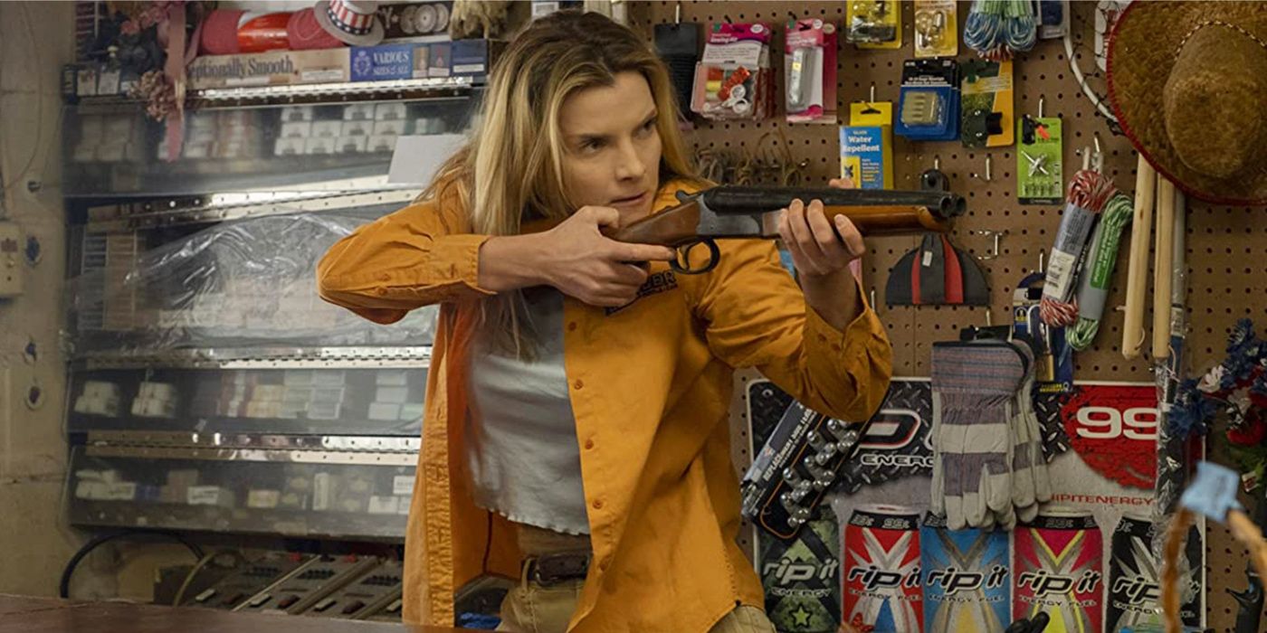 Crystal May Creasey (Betty Gilpin) is aiming a double-barrel shotgun in a hardware store in The Hunt.