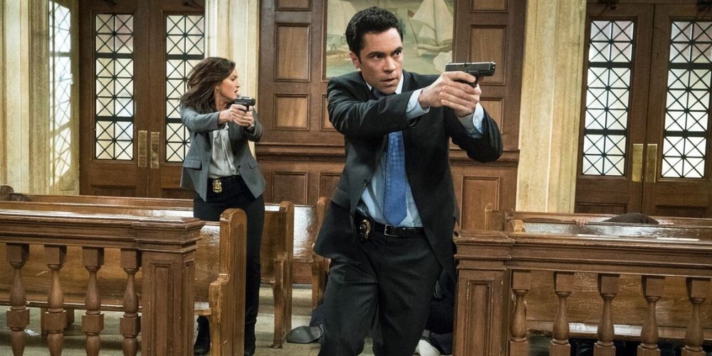 Mariska Hargitay as Olivia Benson runs through a court room with Danny Pino as Nick Amaro in SVU's Surrendering Noah