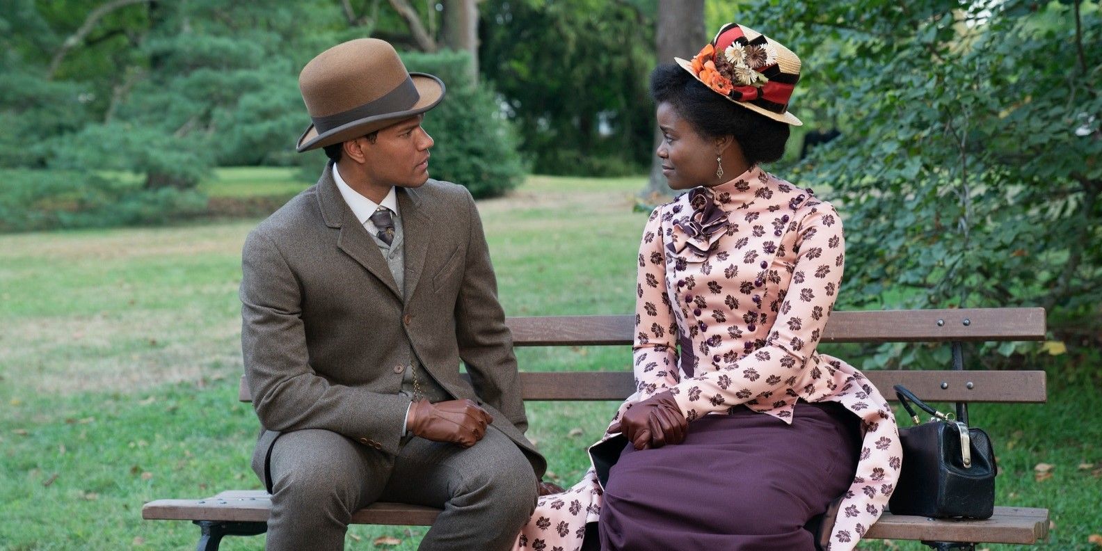 T. Thomas Fortune and Peggy Scott sitting on a bench in The Gilded Age Season 2.