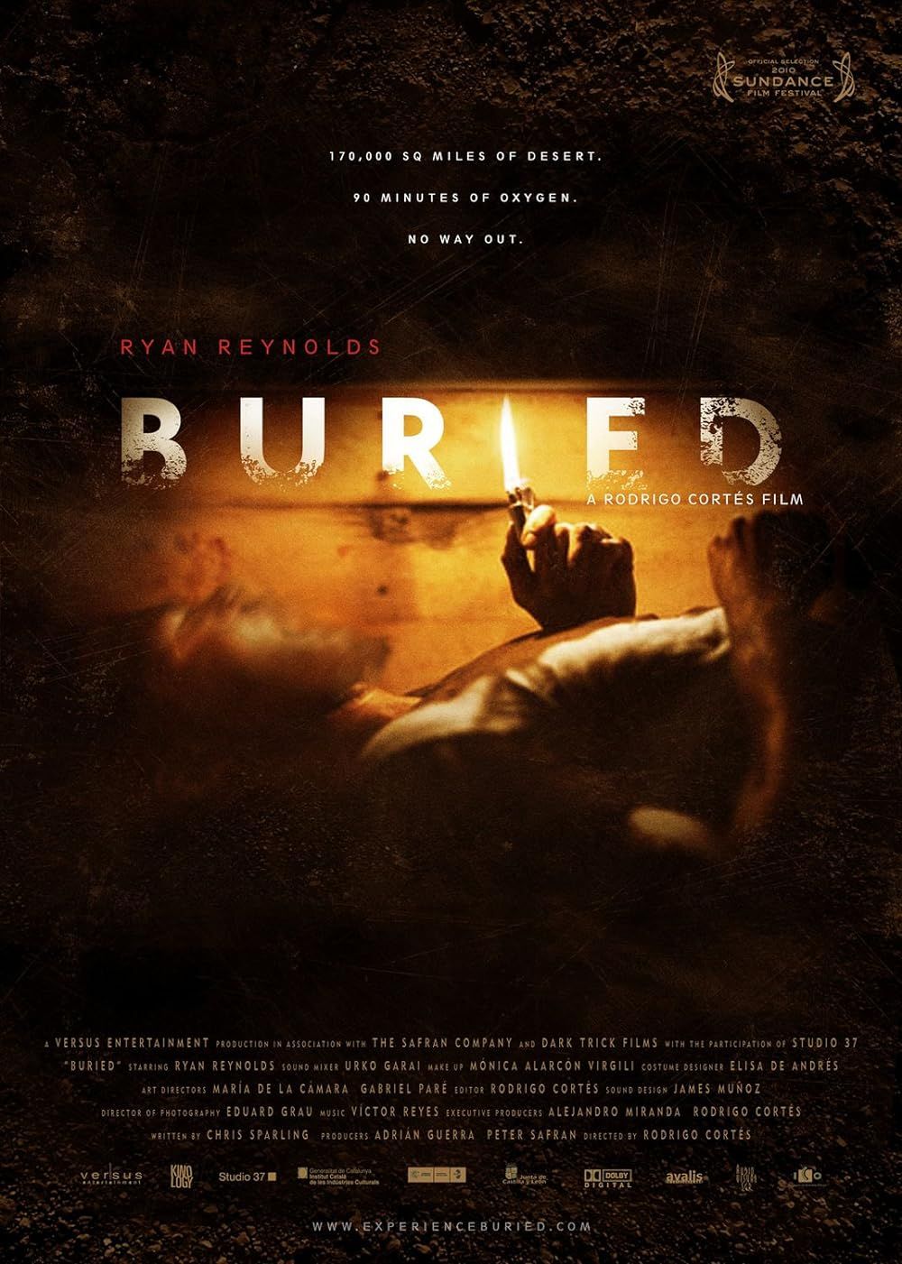 A man uses a lighter to see inside a buried box in the poster of Buried