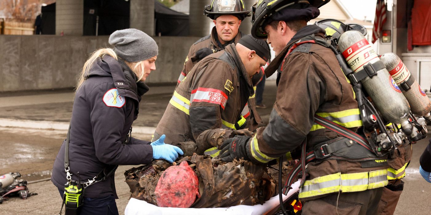 Brett (played by Kara Killmer) and two firefighters tend to a badly burned man in Chicago Fire