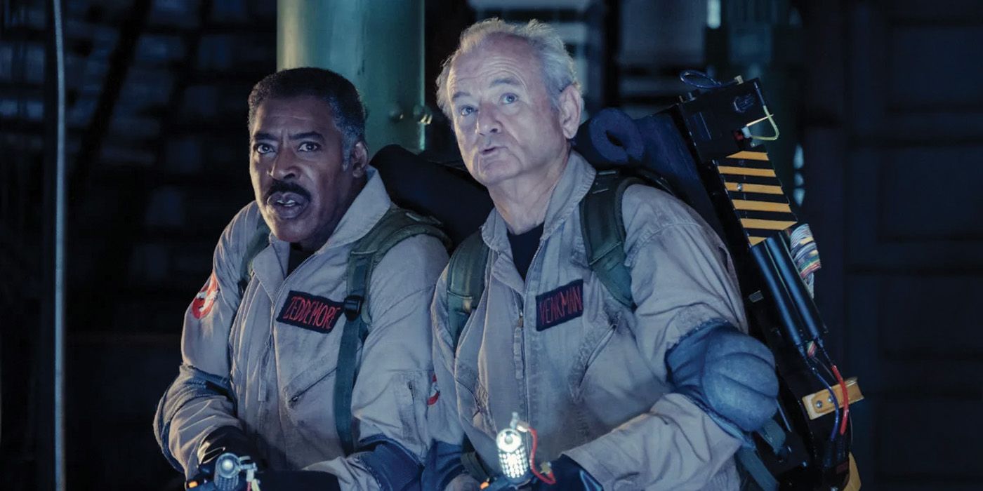 Dr. Winston Zeddemore (Ernie Hudson) and Dr. Peter Venkman (Bill Murray) in their Ghostbusters outfits stare up at an unknown ghost in Frozen Empire.