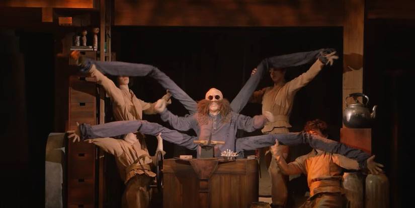 A live-action Kamaji being lifted by stagehands in Sprited Away: Live on Stage.