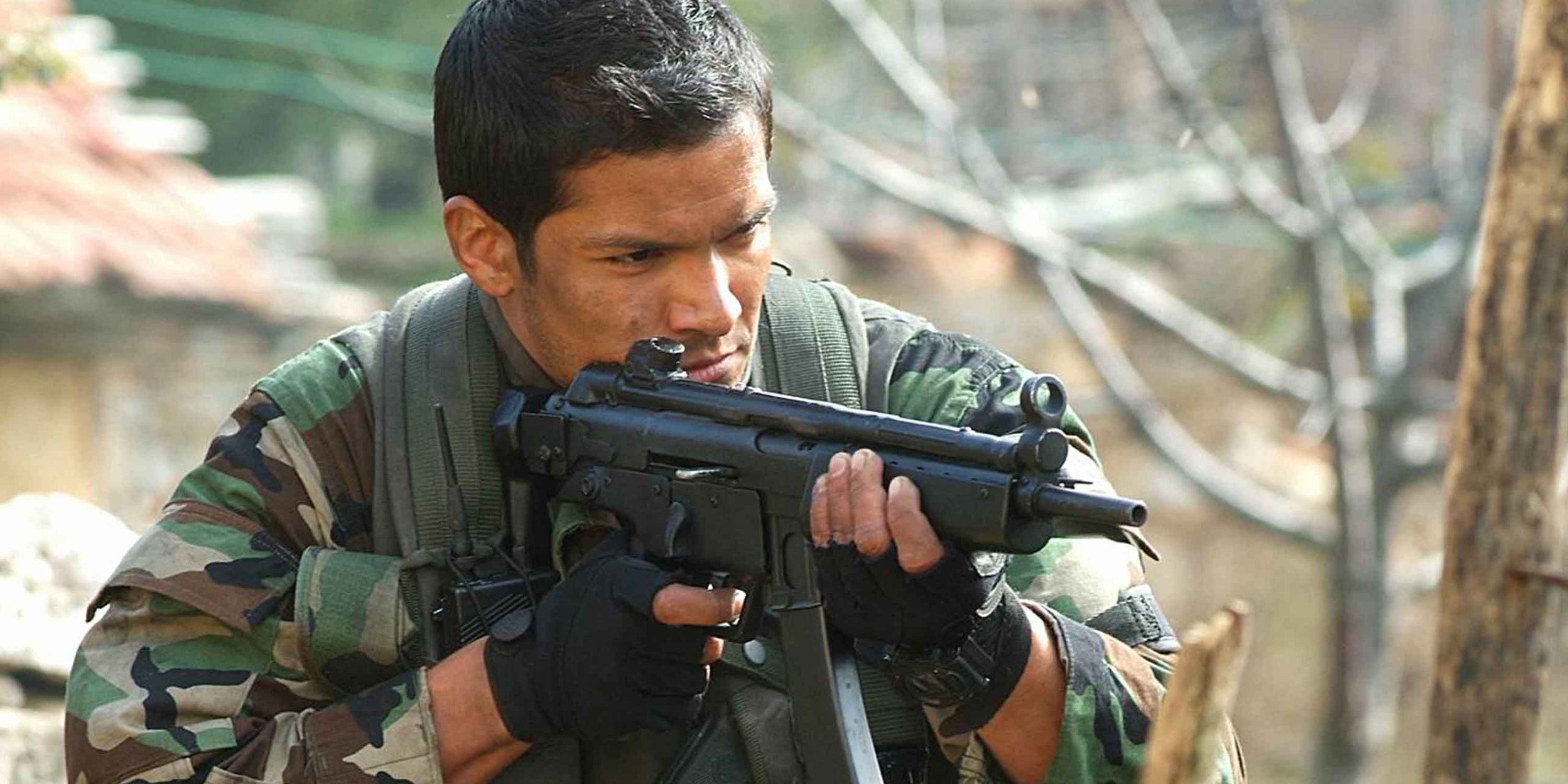 Lt Robert James points a sub machine gun in Behind Enemy Lines II